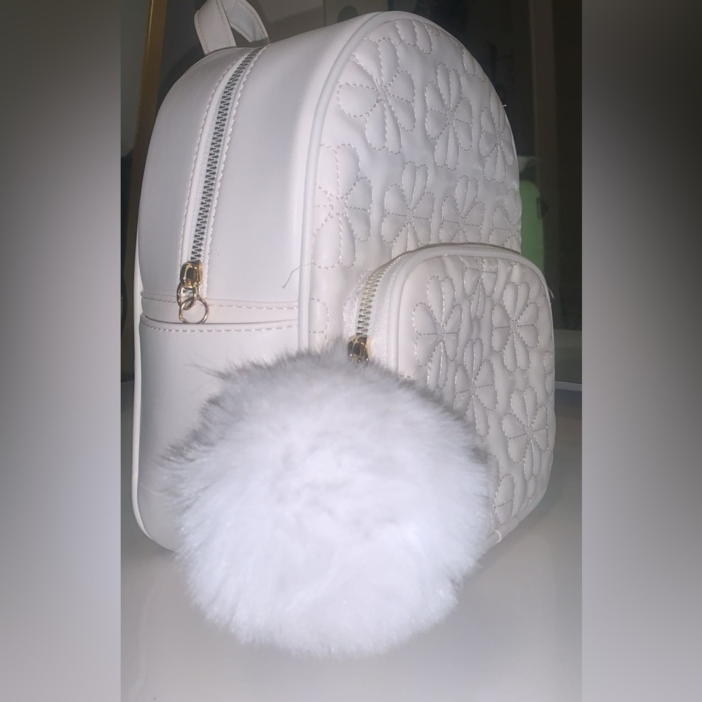 Forever 21 White Floral Backpack with Pom Pom 
Light Gold plated zipper.
